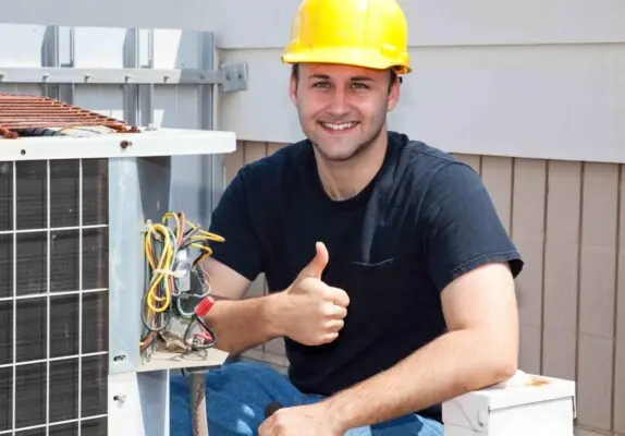 Smiling HVAC technician giving thumbs up after completing air conditioning repair in Dallas