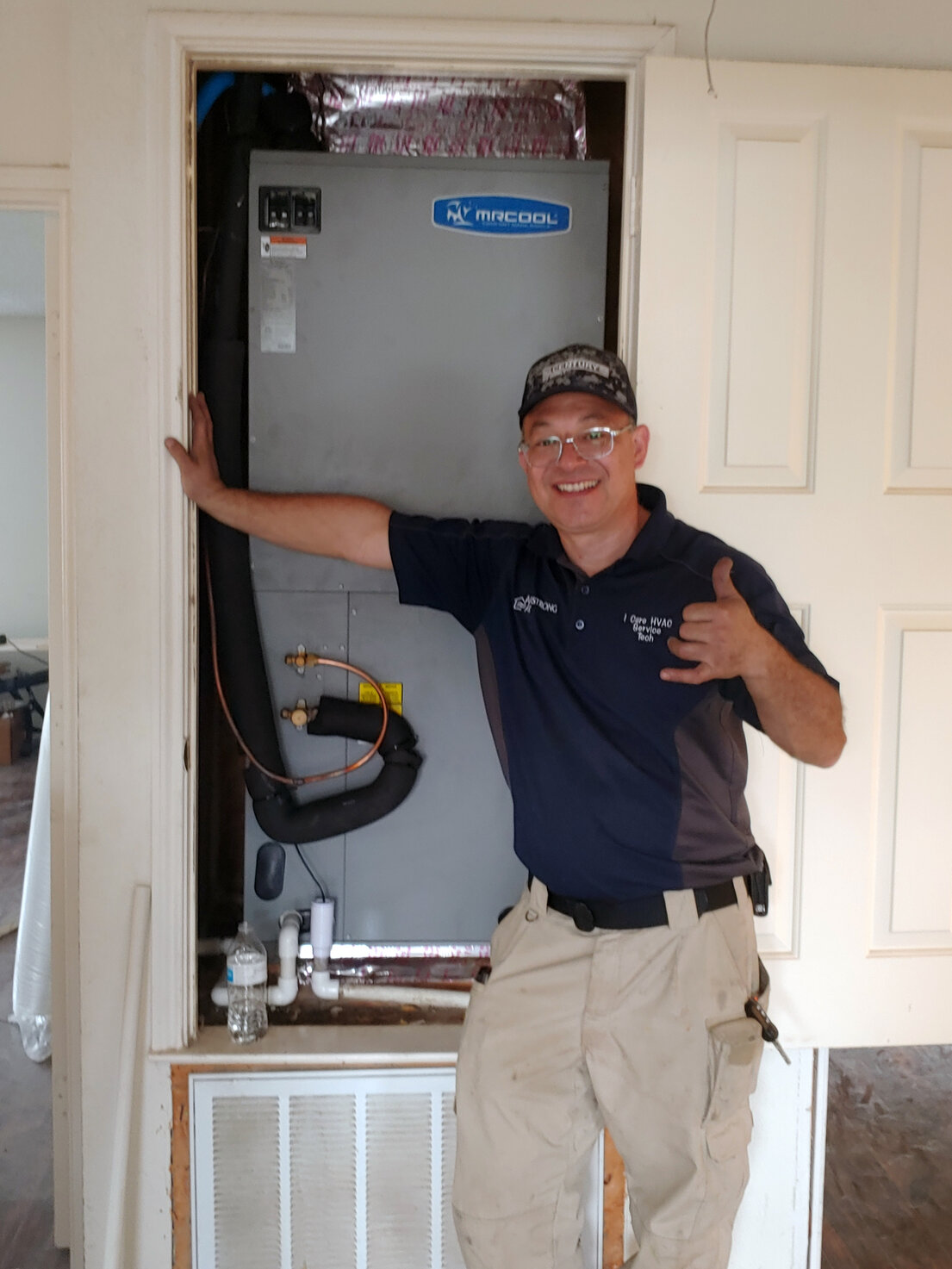 Technician repairing central air conditioner