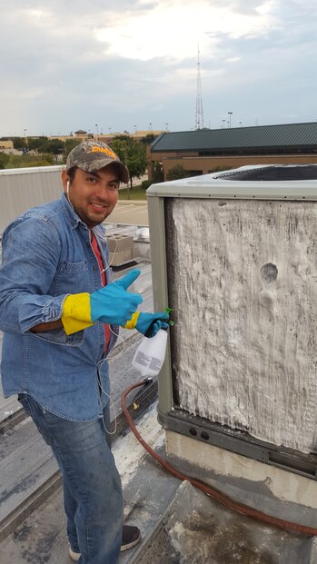 Technician repairing central air conditioner